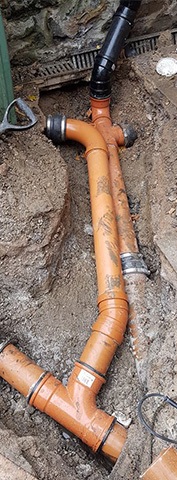 inspecting exposed drainage pipes